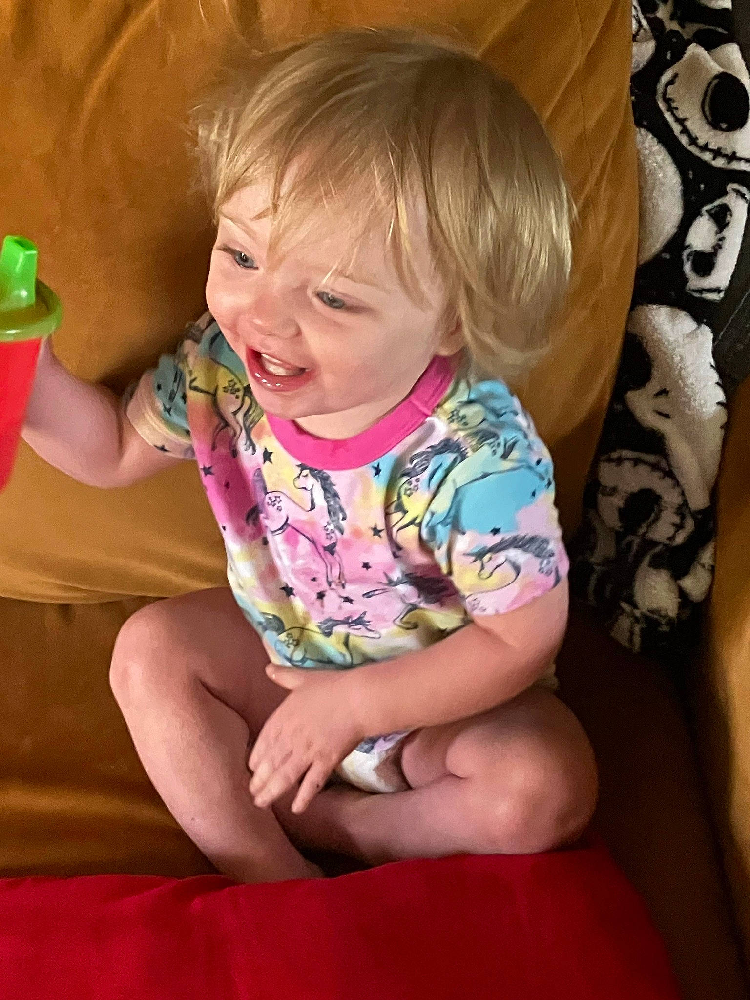 Harlow is registered to the contest to win money with this photo: baby_toddler_clothing, blond, cheek, child, comfort, facial_expression, finger, fun, hand, happy, human_body, human_leg, leisure, person, pink, sitting, skin, smile, thigh, thumb