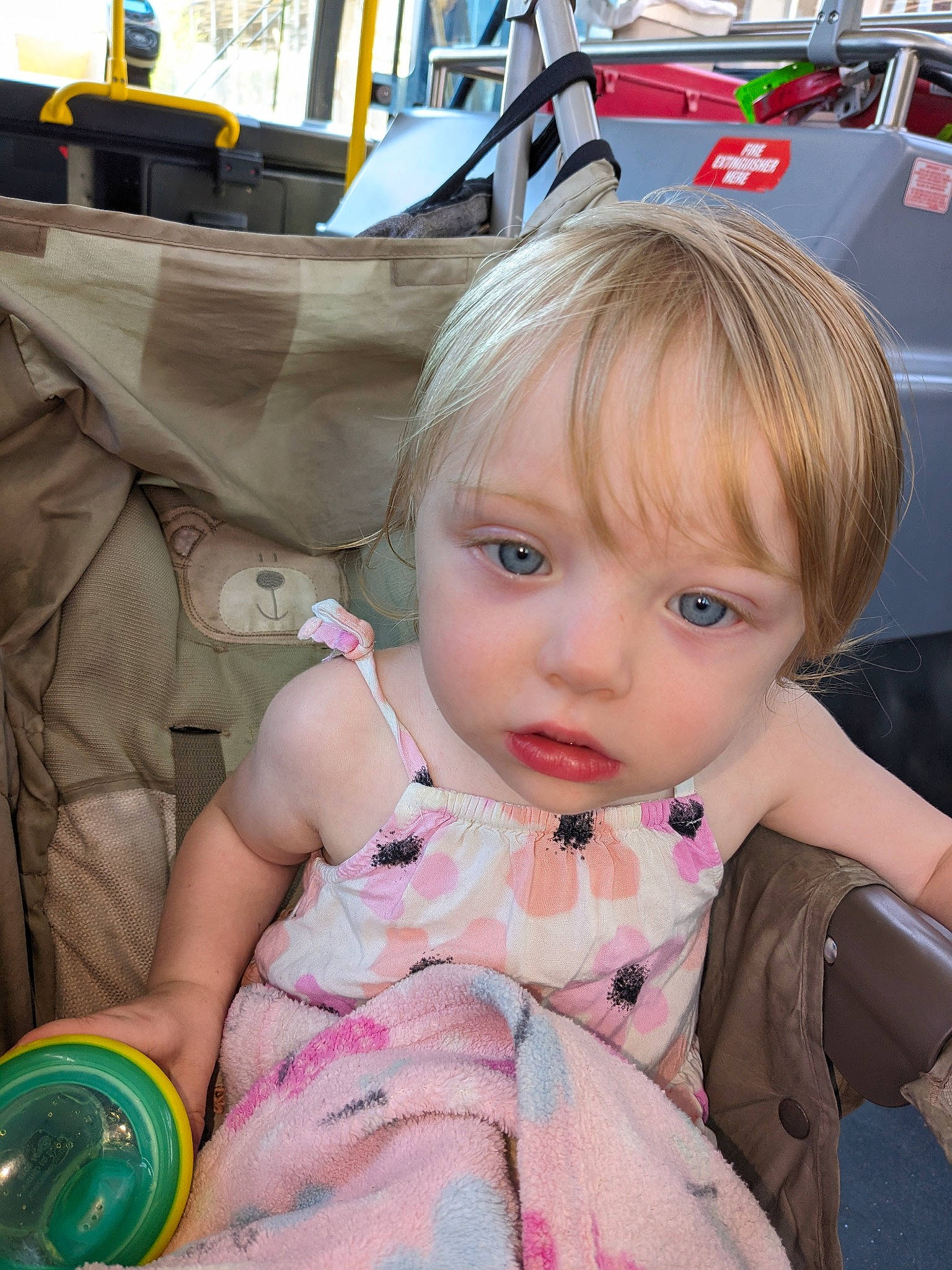 Harlow is registered to the contest to win money with this photo: auto_part, automotive_exterior, baby, baby_products, baby_toddler_clothing, bangs, child, fun, grass, happy, leisure, motor_vehicle, pattern, person, pink, play, recreation, sitting, toddler, travel