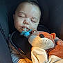 baby, sleeping, pacifier, plush_toy, fox, car_seat, striped_clothing, child, infant, hands, soft_toy, cute, peaceful, indoors, portrait, young_child, cozy, nursery, resting, childcare