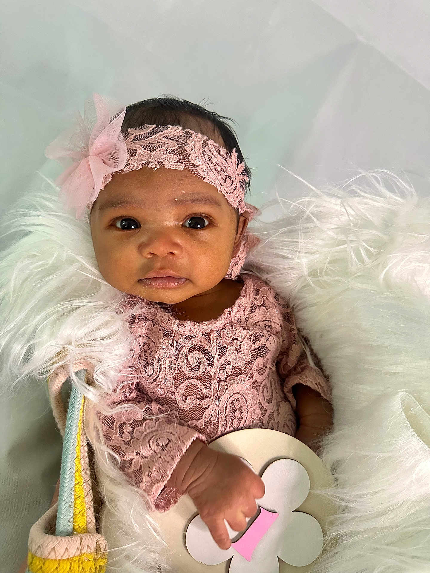 Elianna joined the competition — help win amazing prizes! baby, infant, pink_lace, headband, flower_accessory, blanket, fluffy, basket, toy, wooden_toy, hand, face, eyes, portrait, cute, soft_texture, indoor, newborn, child, cozy