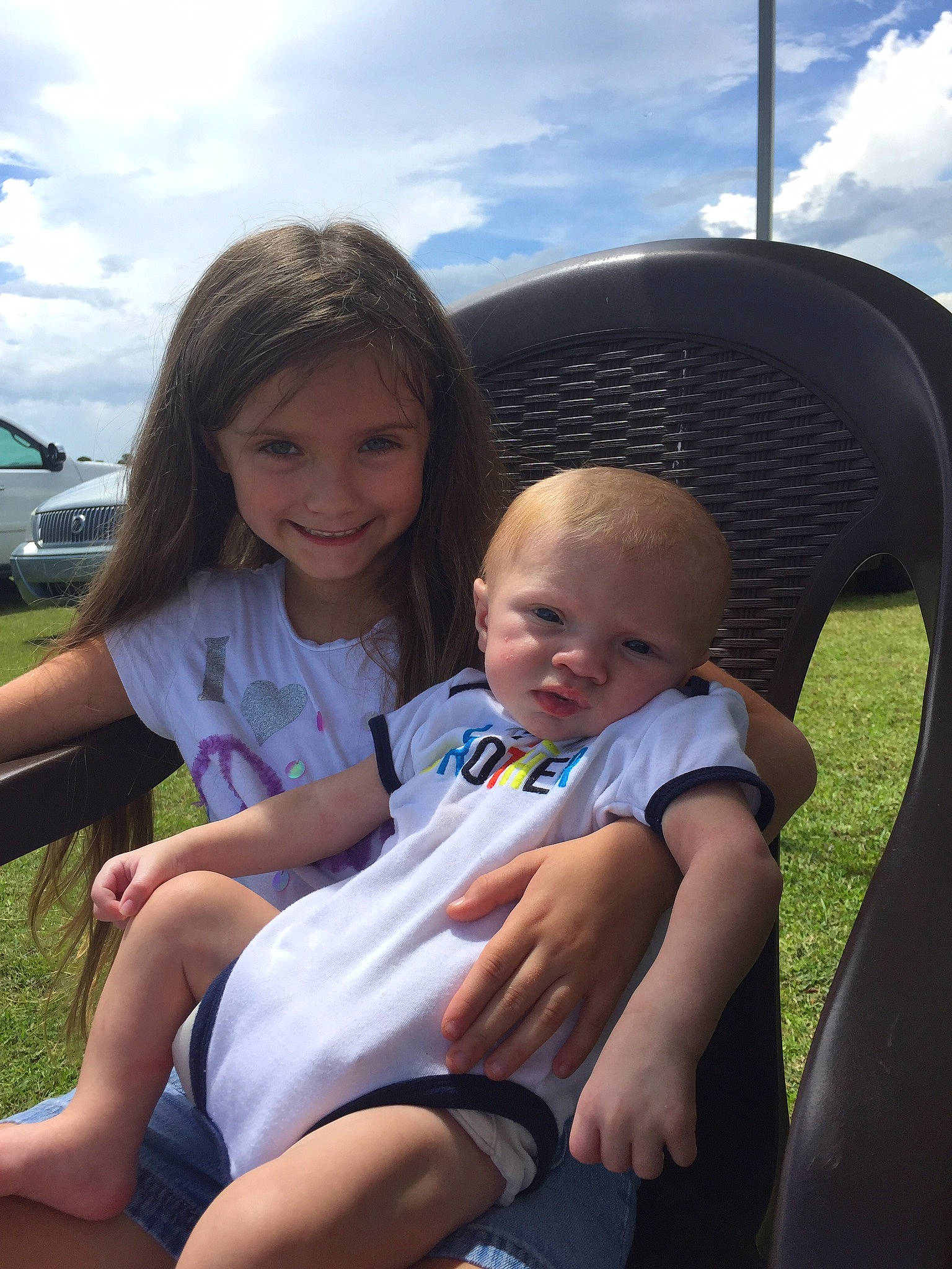 Kaidance is registered to the contest to win money with this photo: car, car_seat, child, day, fun, girl, grass, infant, joy, lap, leisure, people, person, product, recreation, sitting, smile, summer, toddler, vacation