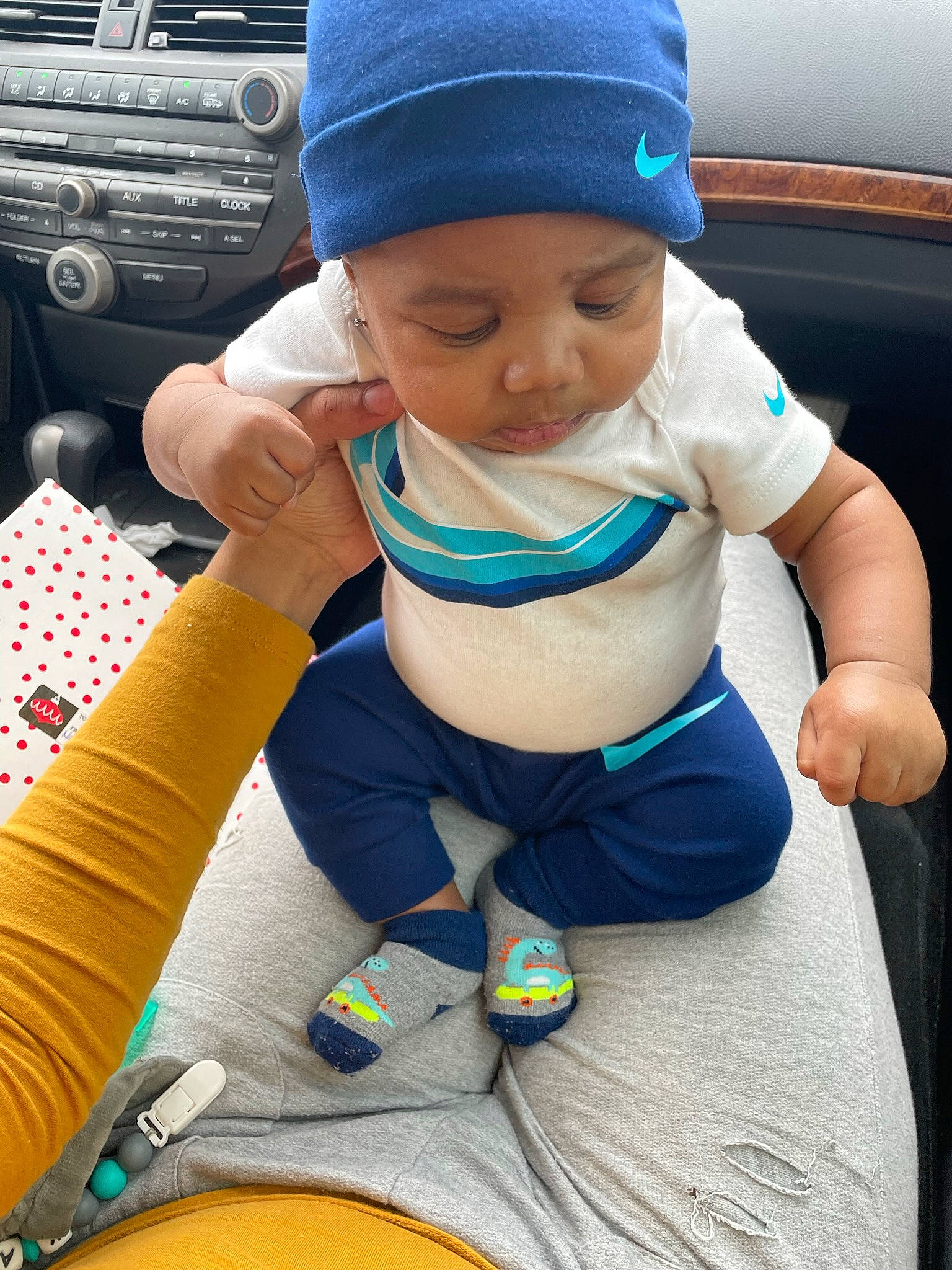 Kash is registered to the contest to win money with this photo: baby, baby_toddler_clothing, baseball_cap, blue, cap, clothing, comfort, cool, face, facial_expression, finger, hand, headgear, headwear, human_body, outerwear, person, product, skin, thigh