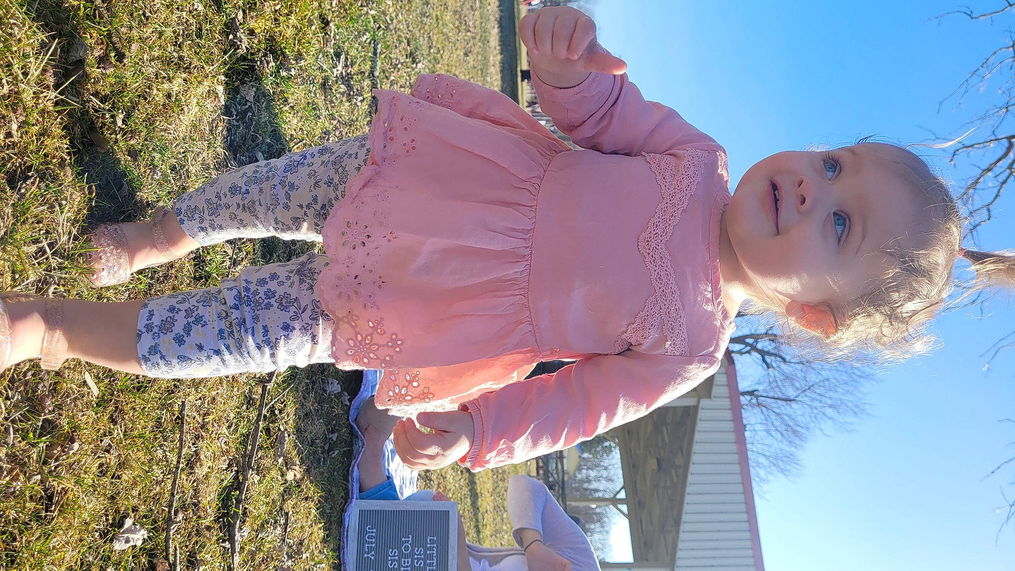 Evee is registered to the contest to win money with this photo: baby, child, cool, fun, gesture, grass, happy, hat, leisure, light, person, pink, plant, sky, smile, textile, toddler, tree, vacation, water