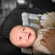 Julyan is registered to the contest to win money with this photo: baby, blanket, child, closeup, clothing, couch, cozy, face, furniture, hand, happy, human, indoor, infant, newborn, person, portrait, relaxing, skin, smiling