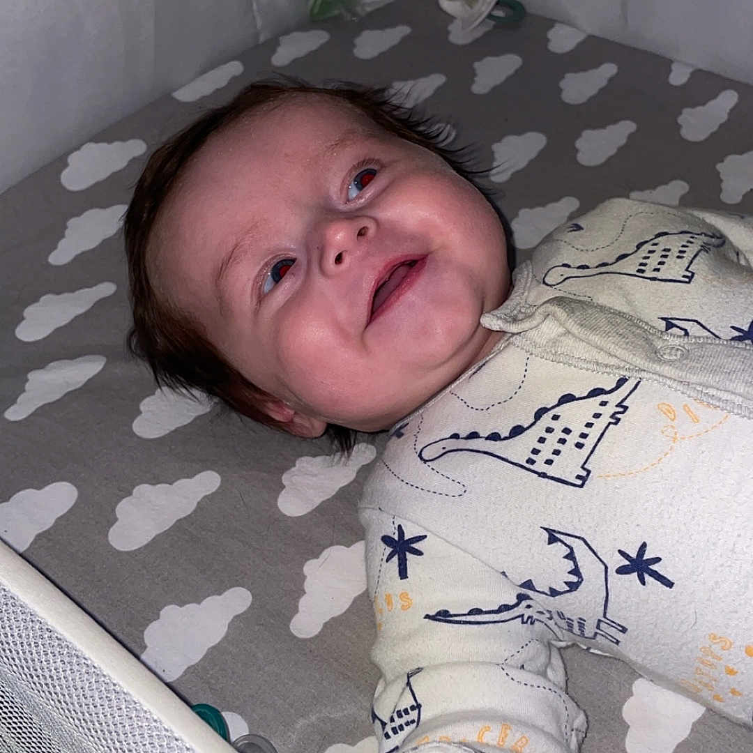 Arlo is registered to the contest to win money with this photo: baby, bed, blanket, bodypart, cradle, crib, face, finger, furniture, hand, head, indoors, infantbed, newborn, nursery, person, photography, portrait, room