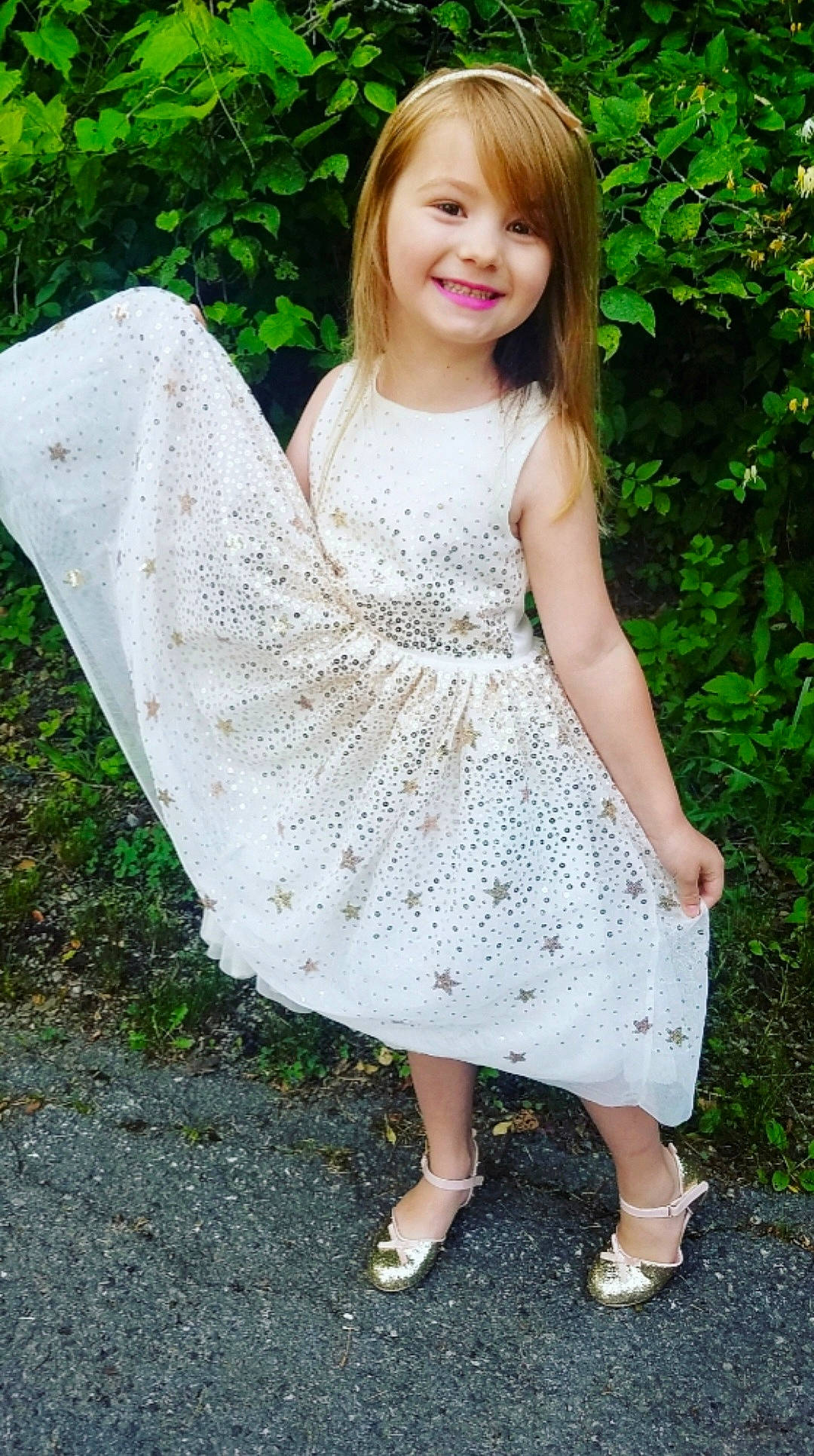 Sophia is registered to the contest to win money with this photo: baby_toddler_clothing, clothing, day_dress, dress, embellishment, facial_expression, grass, hair, happy, joy, one_piece_garment, people_in_nature, person, pink, sleeve, smile, street_fashion, summer, toddler, tree