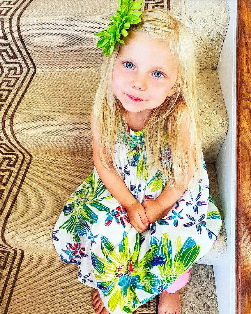 Annalynn joined the competition — help win amazing prizes! baby_toddler_clothing, dress, eye, eyelash, face, facial_expression, grass, green, hairstyle, happy, head, iris, joy, leaf, people_in_nature, person, plant, skin, sleeve, smile