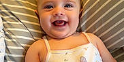 Maddison joined the competition — help win amazing prizes! baby, smiling, infant, onesie, fairy, butterfly, pillow, striped, cute, happy, child, portrait, lying_down, indoors, soft_lighting, skin, face, arm, hand, baby_clothing