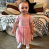 Athena joined the competition — help win amazing prizes! child, toddler, pink_dress, smiling, standing, carpet, couch, blanket, knitted_blanket, home_interior, decorations, picture_frame, door, white_shoes, person, happy, indoors, young_child, clothing, floor