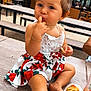 Syanna participe au concours pour gagner de l'argent avec cette photo : toddler, child, girl, face, finger_in_mouth, french_fries, bracelet, earrings, flower_pattern, dress, table, outdoor, picnic_table, hair_tied, food, snack, summer, daylight, casual, cute