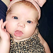 Emma joined the competition — help win amazing prizes! baby, cheeks, child, closeup, clothing, cute, expression, eyes, face, fashion, hand, headband, indoors, infant, leopard_print, person, pink_bow, portrait, skin, young