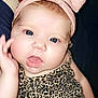 baby, cheeks, child, closeup, clothing, cute, expression, eyes, face, fashion, hand, headband, indoors, infant, leopard_print, person, pink_bow, portrait, skin, young