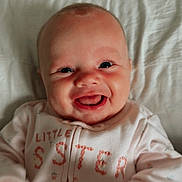 Eleanor is registered to the contest to win money with this photo: baby, infant, smiling, onesie, clothing, face, hands, happy, child, cute, portrait, indoors, bed, candid, person, young, joy, expression, skin, babywear