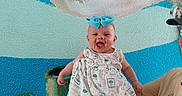Eleanor joined the competition — help win amazing prizes! baby, child, smiling, blue_bow, dress, person, hand, underwater_mural, sea_turtle, coral, wall_art, colorful, happy, portrait, indoor, skin, headband, adult_hand, vibrant, cute