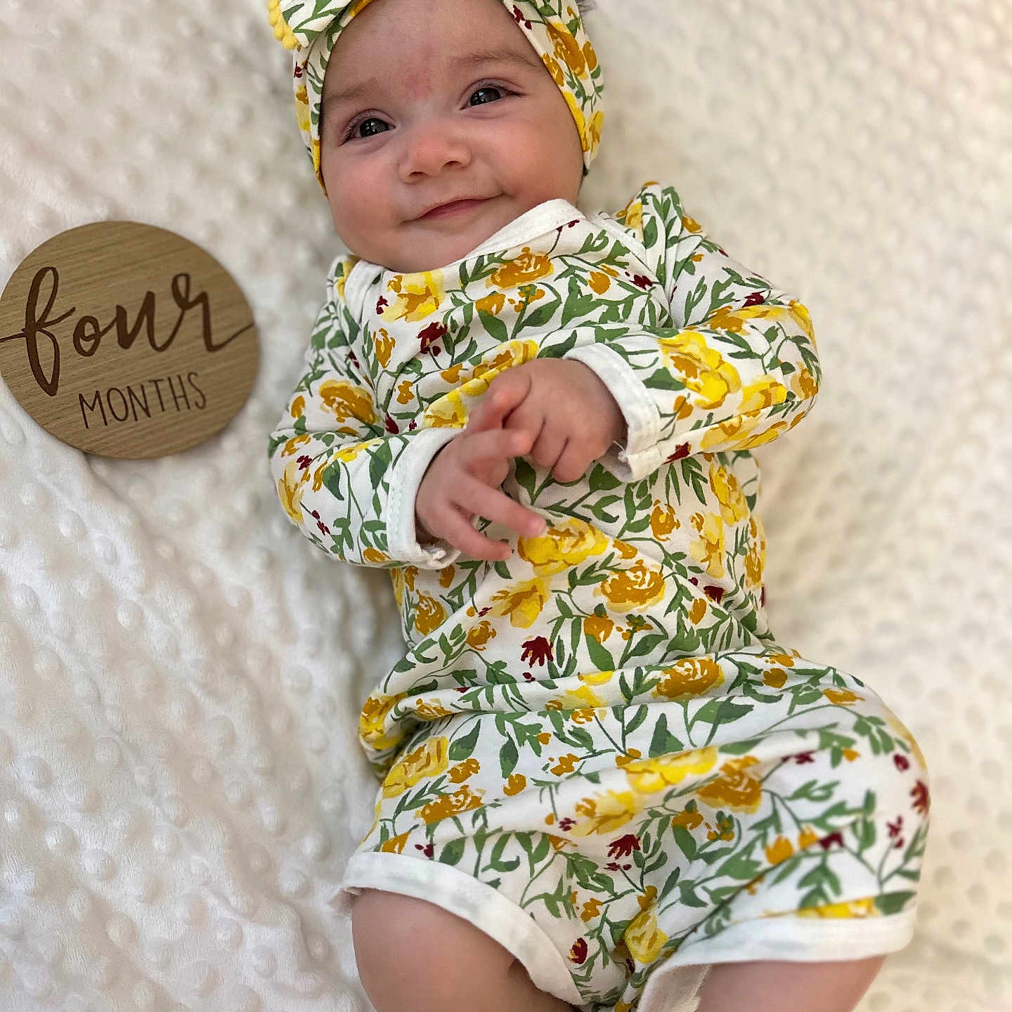 Elliana joined the competition — help win amazing prizes! baby, beachwear, blanket, bonnet, cap, clothing, dress, face, happy, hat, head, newborn, pattern, person, photography, portrait, quilt, sitting, sleeve, smile