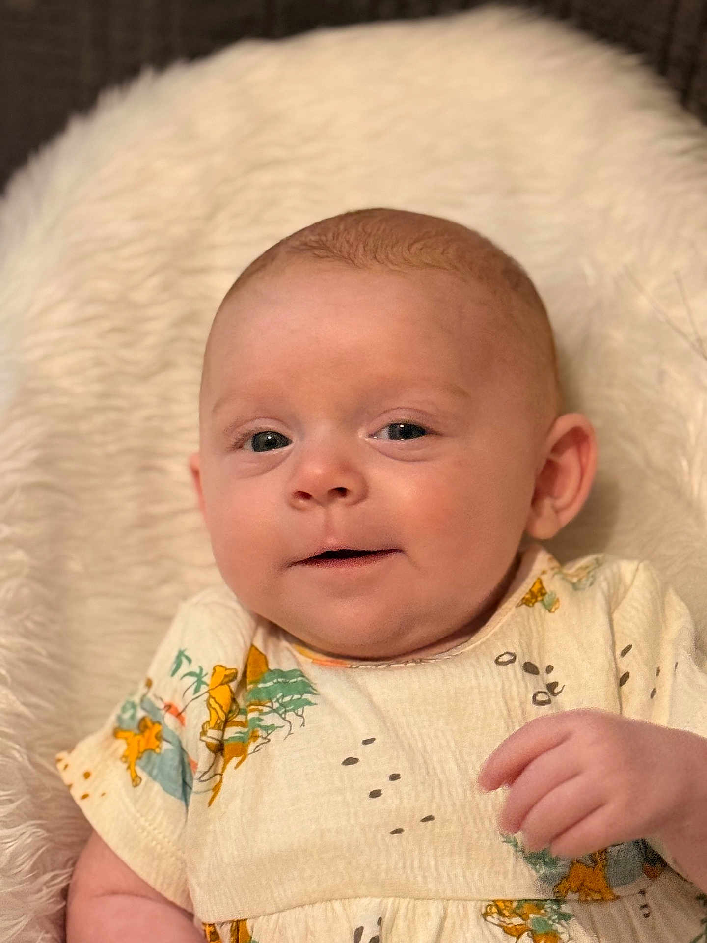 Lola joined the competition — help win amazing prizes! baby, infant, face, child, cute, smile, clothing, blanket, soft, portrait, skin, hand, expression, young, indoors, cuteness, person, newborn, animal_print, resting