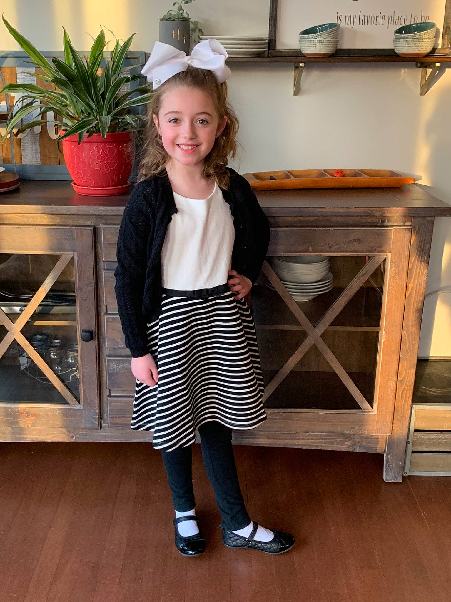 Rylee is registered to the contest to win money with this photo: child, child_model, clothing, footwear, furniture, joy, leg, neck, outerwear, person, shoe, shorts, sleeve, standing, t_shirt, tights, toddler, waist