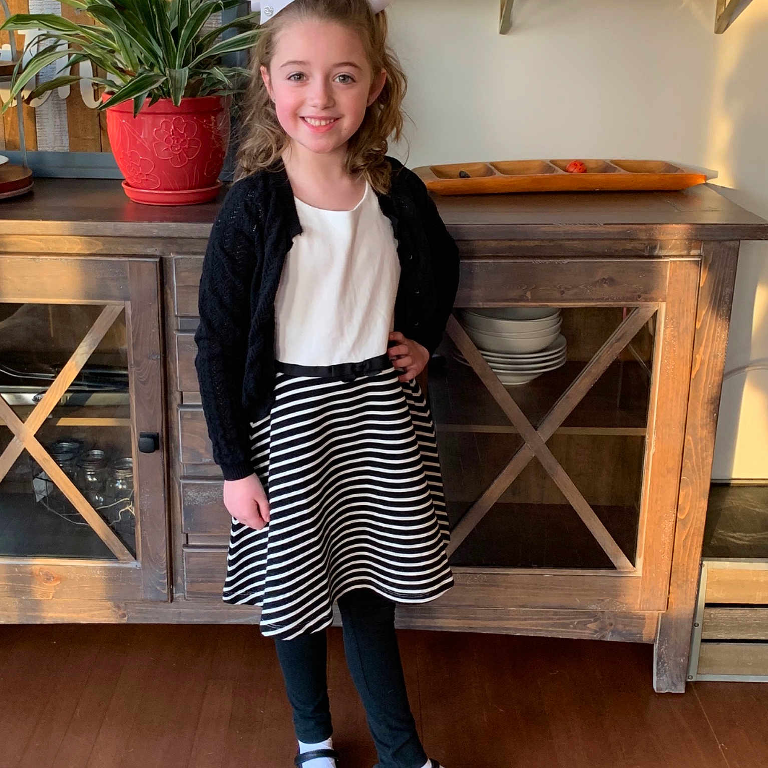 Rylee is registered to the contest to win money with this photo: child, child_model, clothing, footwear, furniture, joy, leg, neck, outerwear, person, shoe, shorts, sleeve, standing, t_shirt, tights, toddler, waist