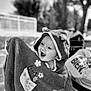 baby, child, hooded_towel, smiling, outdoor, black_and_white, happy, portrait, face, towel, cute, infant, expression, playful, sunlight, nature, blurred_background, clothing, young_child, joy