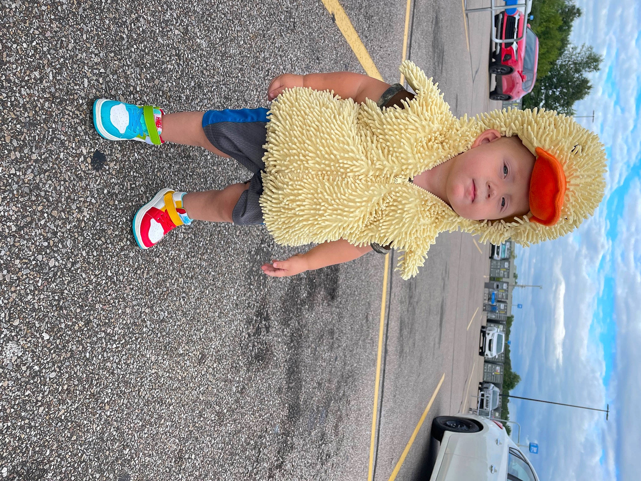 Mathias is registered to the contest to win money with this photo: asphalt, blue, car, child, electric_blue, foot, fun, headwear, human_leg, leisure, person, recreation, road_surface, sidewalk, sky, thigh, tire, toddler, vehicle_door, walking_shoe