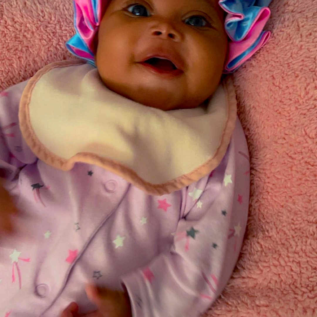 Miyourie joined the competition — help win amazing prizes! baby, bed, blanket, bonnet, cap, clothing, cushion, face, furniture, happy, hat, head, homedecor, newborn, person, photography, portrait, purple, quilt, smile