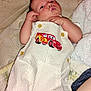 Wyatt is registered to the contest to win money with this photo: baby, blanket, car_patch, child, cute, expression, fabric, face, footwear_absent, hand, indoors, infant, legs, lying_down, overalls, person, pillow, skin, soft_texture, striped_clothing
