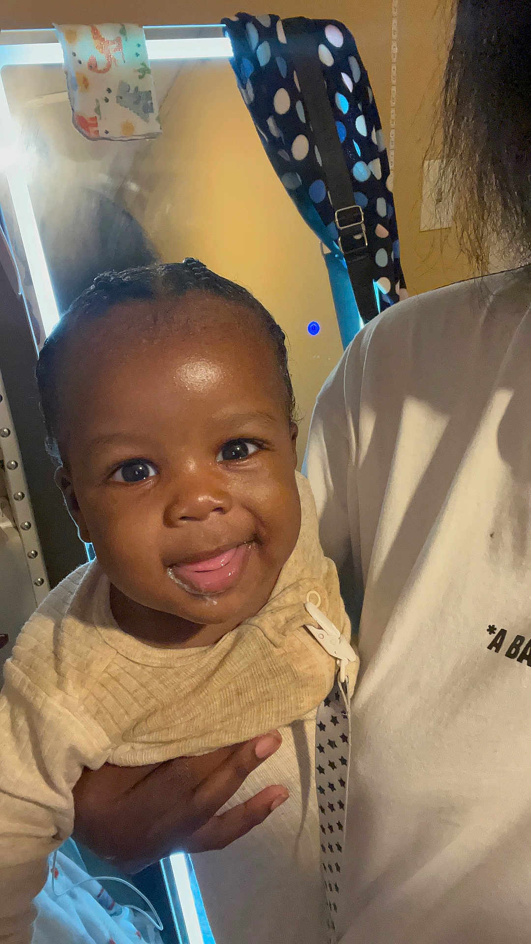 Hyndrex joined the competition — help win amazing prizes! baby, child, smile, tongue_out, indoor, person, hand, shirt, mirror, towel, polka_dot, hair, face, clothing, holding, happy, closeup, portrait, skin, expression
