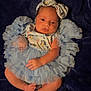 baby, infant, blue_dress, headband, ruffles, blanket, lying_down, cute, newborn, soft_lighting, infant_clothing, skin, foot, hand, portrait, indoors, person, baby_fashion, baby_girl, sleepwear