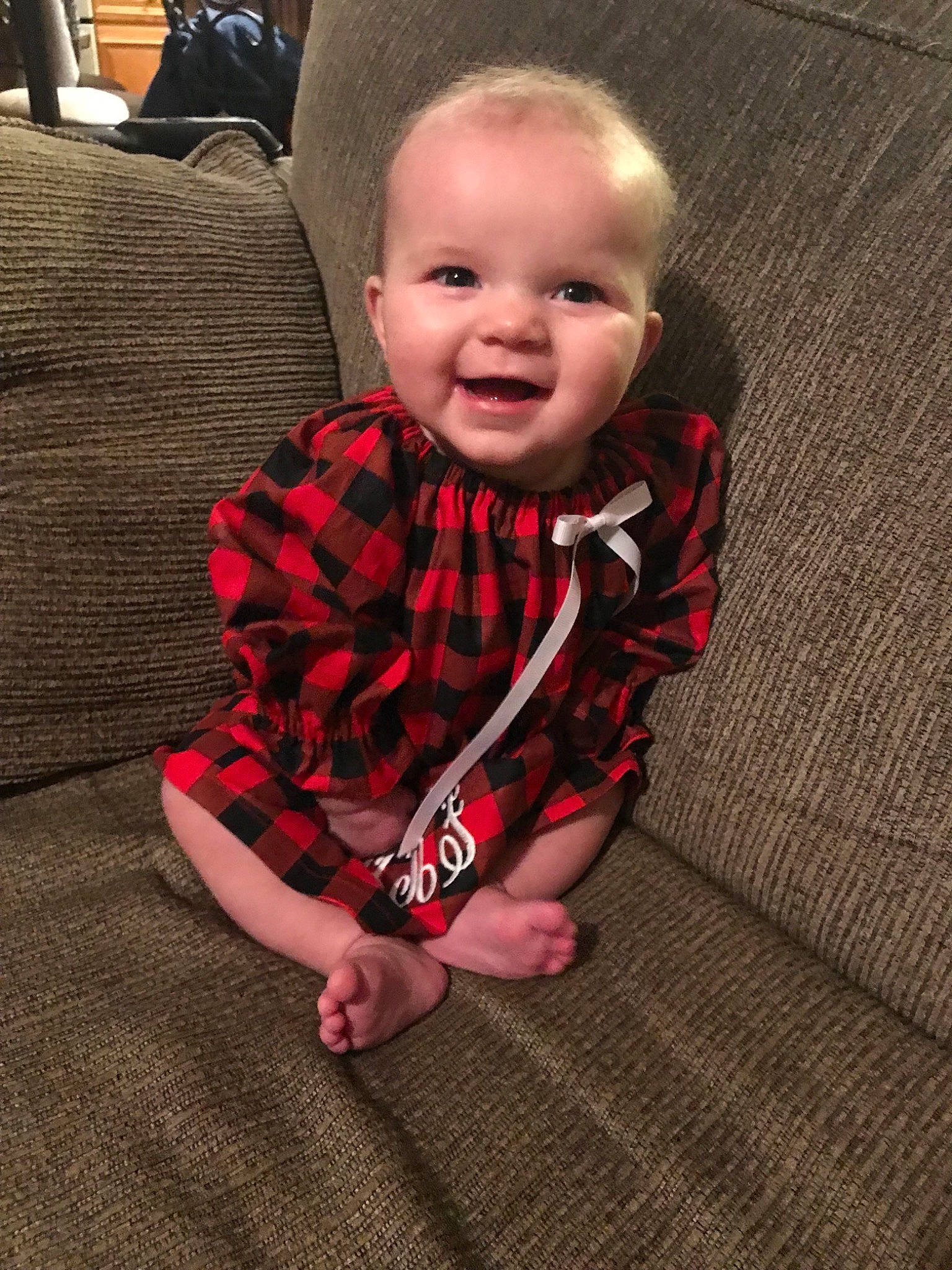 Madalyn joined the competition — help win amazing prizes! baby, cheek, child, cool, design, electronic_device, eye, face, facial_expression, flooring, head, leg, nose, outerwear, pattern, person, sitting, skin, smile, toddler