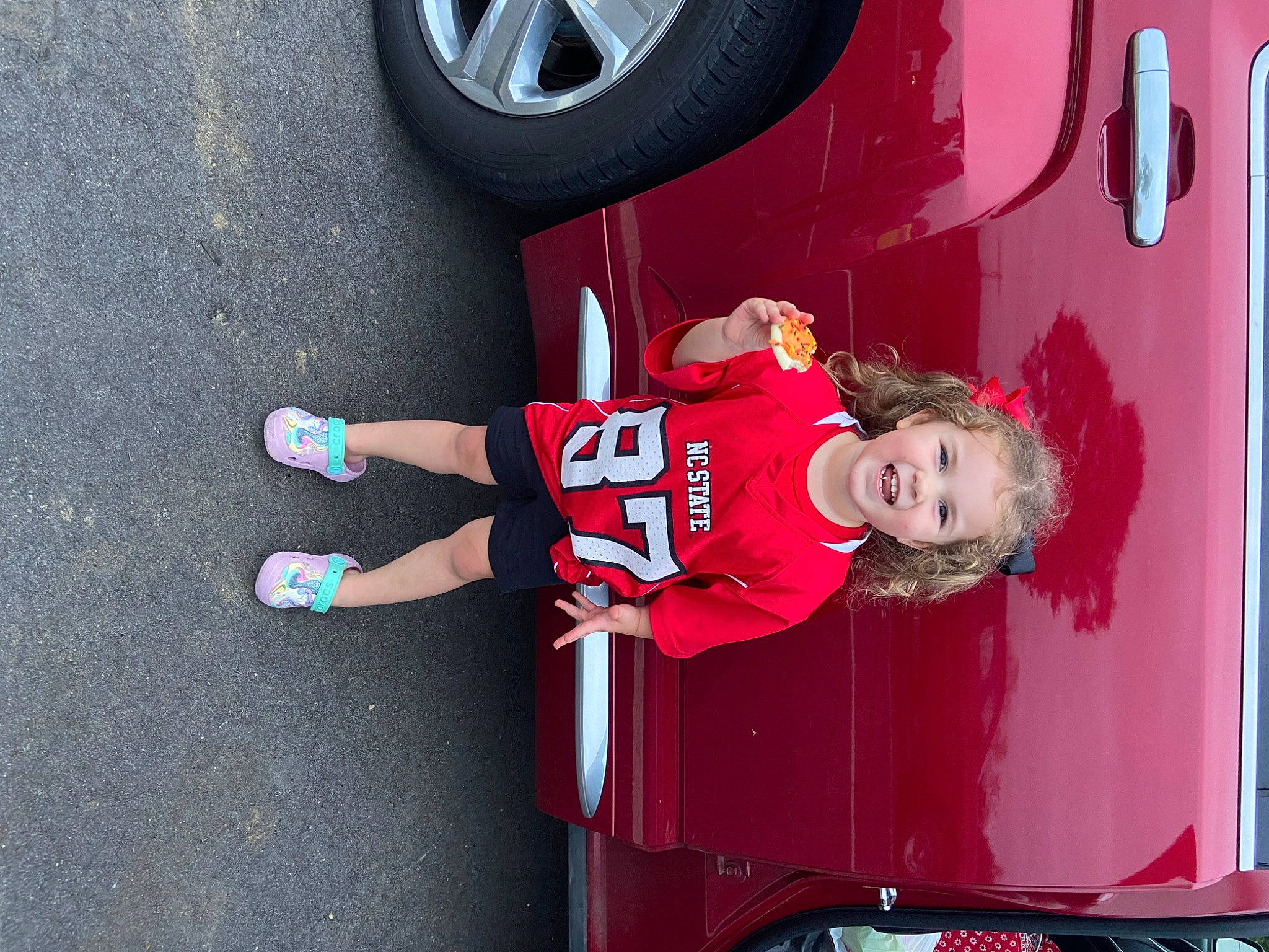 Madalyn joined the competition — help win amazing prizes! automotive_design, automotive_exterior, automotive_lighting, automotive_tire, bumper, car, fender, hubcap, joy, leg, motor_vehicle, person, pink, red, rolling, shorts, tire, tread, vehicle, vehicle_door