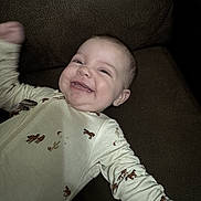 Celene joined the competition — help win amazing prizes! baby, smiling, onesie, couch, happy, infant, child, clothing, face, person, indoor, cute, young, baby_gesture, expression, baby_sleepwear, relaxed, cheerful, baby_fashion, baby_boy