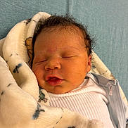 Tayvontae joined the competition — help win amazing prizes! newborn, baby, infant, sleeping, blanket, soft, cute, face, person, child, resting, indoors, clothing, white_shirt, peaceful, closeup, portrait, head, skin, hair