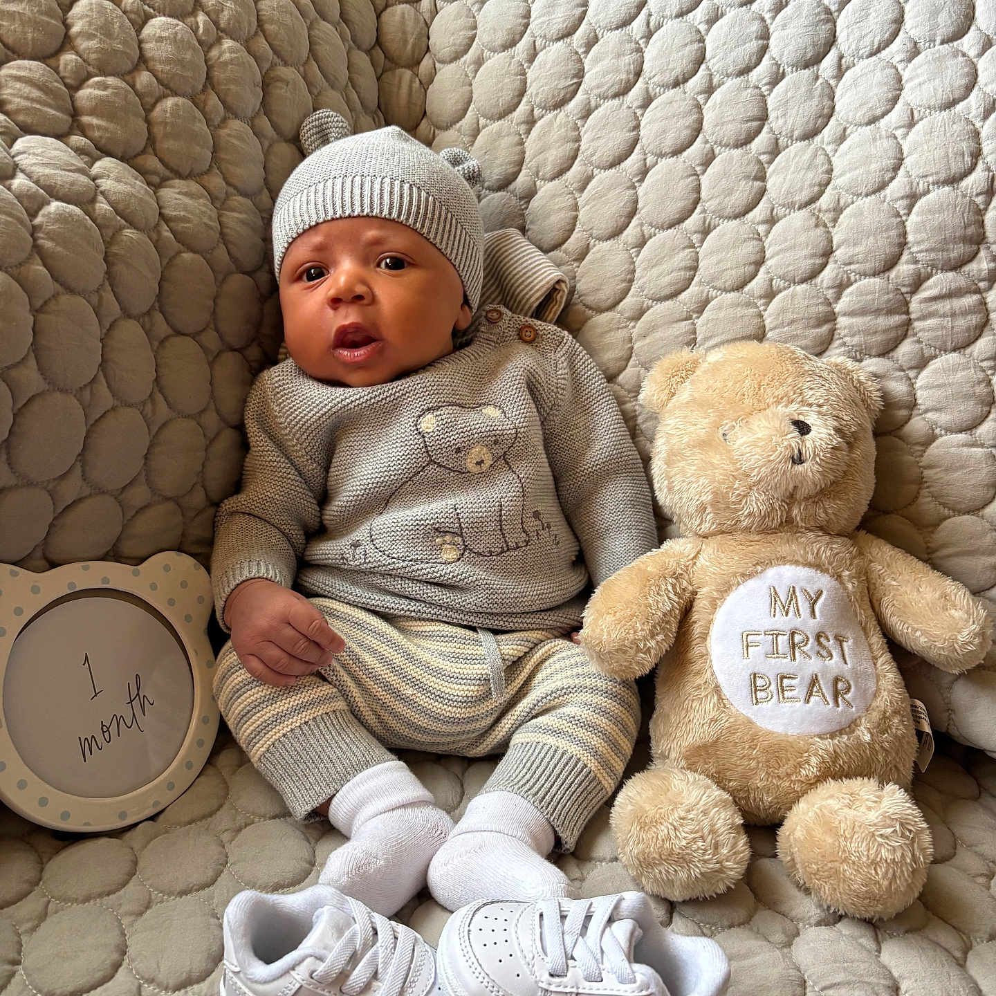 Tayvontae joined the competition — help win amazing prizes! baby, infant, knitwear, hat, plush_toy, teddy_bear, milestone_sign, sneakers, quilted_background, soft_toys, cute, cozy, portrait, sitting, child, white_socks, comfortable, indoor, newborn, baby_clothing