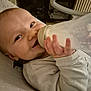 baby, bottle, milk, smile, infant, clothing, hand, face, person, indoor, furniture, radiator, seat, happy, child, cozy, young, feeding, skin, closeup