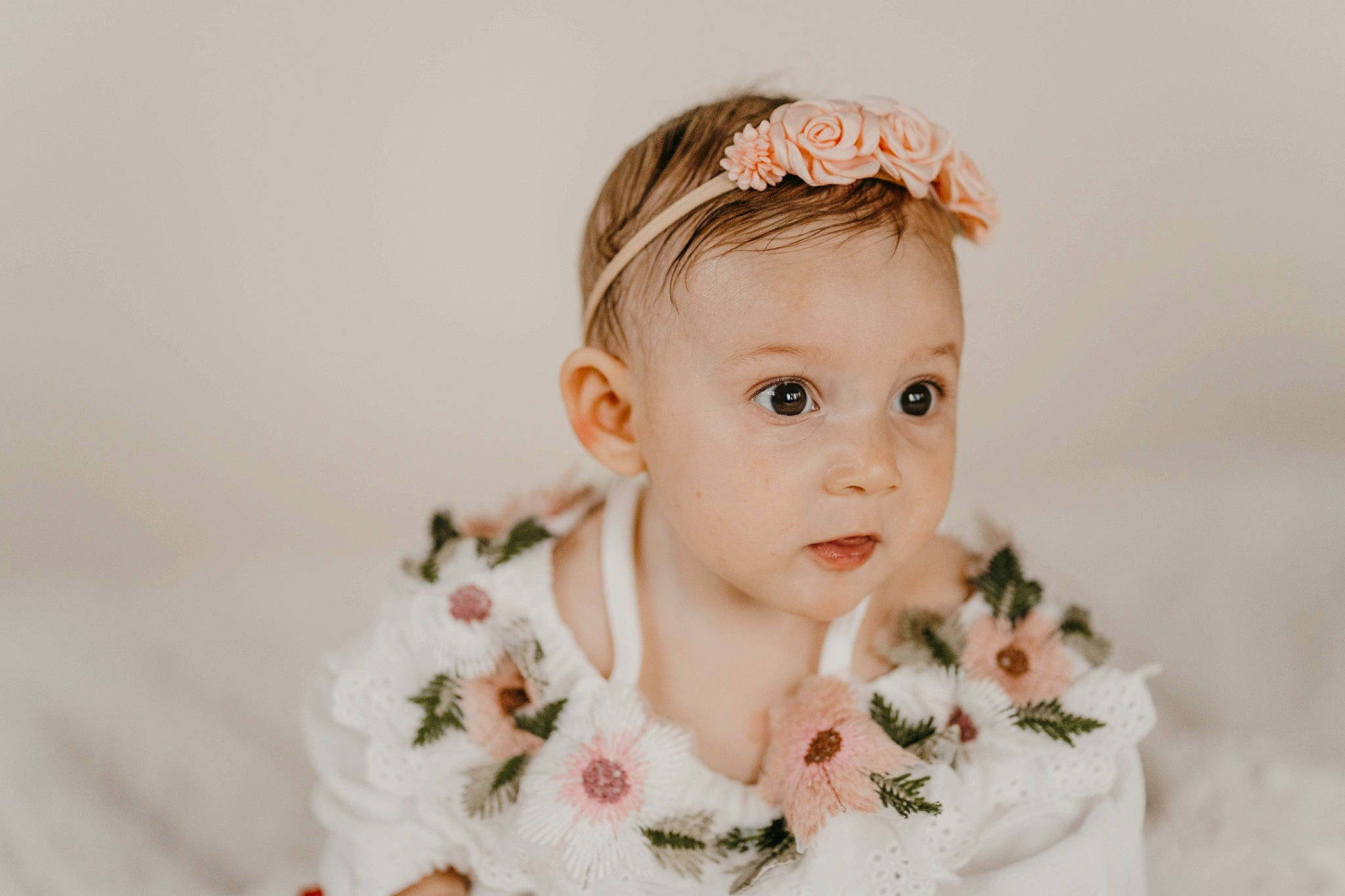 Rosalie is registered to the contest to win money with this photo: baby, baby_toddler_clothing, bridal_accessory, child, collar, embellishment, eyelash, fashion_accessory, flash_photography, hair_accessory, happy, headband, headgear, headpiece, jewellery, pattern, peach, person, petal, sleeve