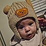 Winter joined the competition — help win amazing prizes! baby, child, knit_hat, bear_patch, ears, curious, indoors, warm_clothing, face, cute, wide_eyes, mouth_open, person, portrait, infant, soft_lighting, cozy, hat, headwear, expression