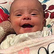 Winter joined the competition — help win amazing prizes! baby, smiling, blanket, face, infant, cozy, pillow, pattern, fabric, cute, happy, portrait, child, soft, comfort, indoor, closeup, head, resting, warm