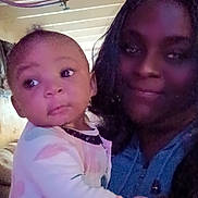 Ma'Laysia joined the competition — help win amazing prizes! adult, baby, casual, ceiling, child, closeup, clothing, curious, face, family, holding, indoor, pajamas, person, pipes, portrait, rustic, smile, together, warm