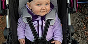 Kiana joined the competition — help win amazing prizes! baby, black_pants, blue_eyes, bow, car, chubby_cheeks, cozy, hands, headband, infant, lavender_color, outdoors, pavement, portrait, purple_jacket, red_hair, seat_harness, smiling, stroller, stroller_canopy