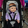 baby, black_pants, blue_eyes, bow, car, chubby_cheeks, cozy, hands, headband, infant, lavender_color, outdoors, pavement, portrait, purple_jacket, red_hair, seat_harness, smiling, stroller, stroller_canopy
