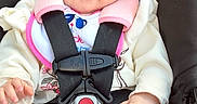 Kiana joined the competition — help win amazing prizes! baby, baby_face, buckle, car_seat, child, closeup, clothing, cute, eyes, floral_pants, hands, headrest, infant, pink, portrait, rosy_cheeks, safety_harness, smile, socks, warning_label