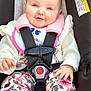 Kiana joined the competition — help win amazing prizes! baby, baby_face, buckle, car_seat, child, closeup, clothing, cute, eyes, floral_pants, hands, headrest, infant, pink, portrait, rosy_cheeks, safety_harness, smile, socks, warning_label