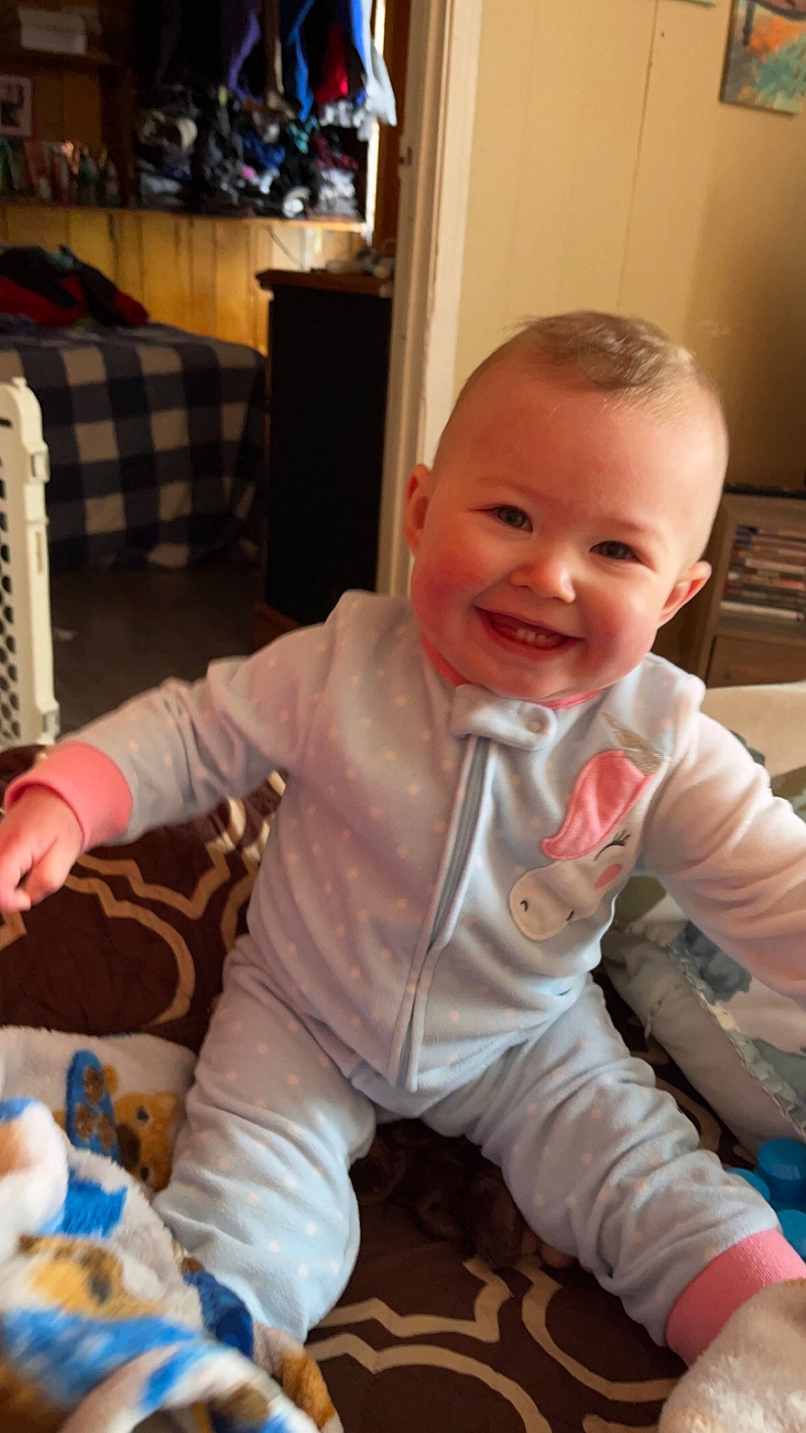 Lilly is registered to the contest to win money with this photo: baby, baby_toddler_clothing, chair, cheek, child, comfort, finger, flooring, fun, happy, head, joy, lap, mouth, person, sitting, skin, sleeve, smile, thumb