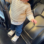 Rayan participe au concours pour gagner de l'argent avec cette photo : child, toddler, car, steering_wheel, sunglasses, sweater, jeans, shoes, seat, leather, interior, portrait, cute, fashion, standing, person, baby, casual, indoor, vehicle