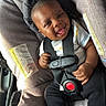 baby, black_hair, car_interior, car_seat, casual_wear, child, clothing, cute, happy, head_support, indoors, infant, joyful, person, safety_harness, seatbelt, small_hands, smile, sock, young_child