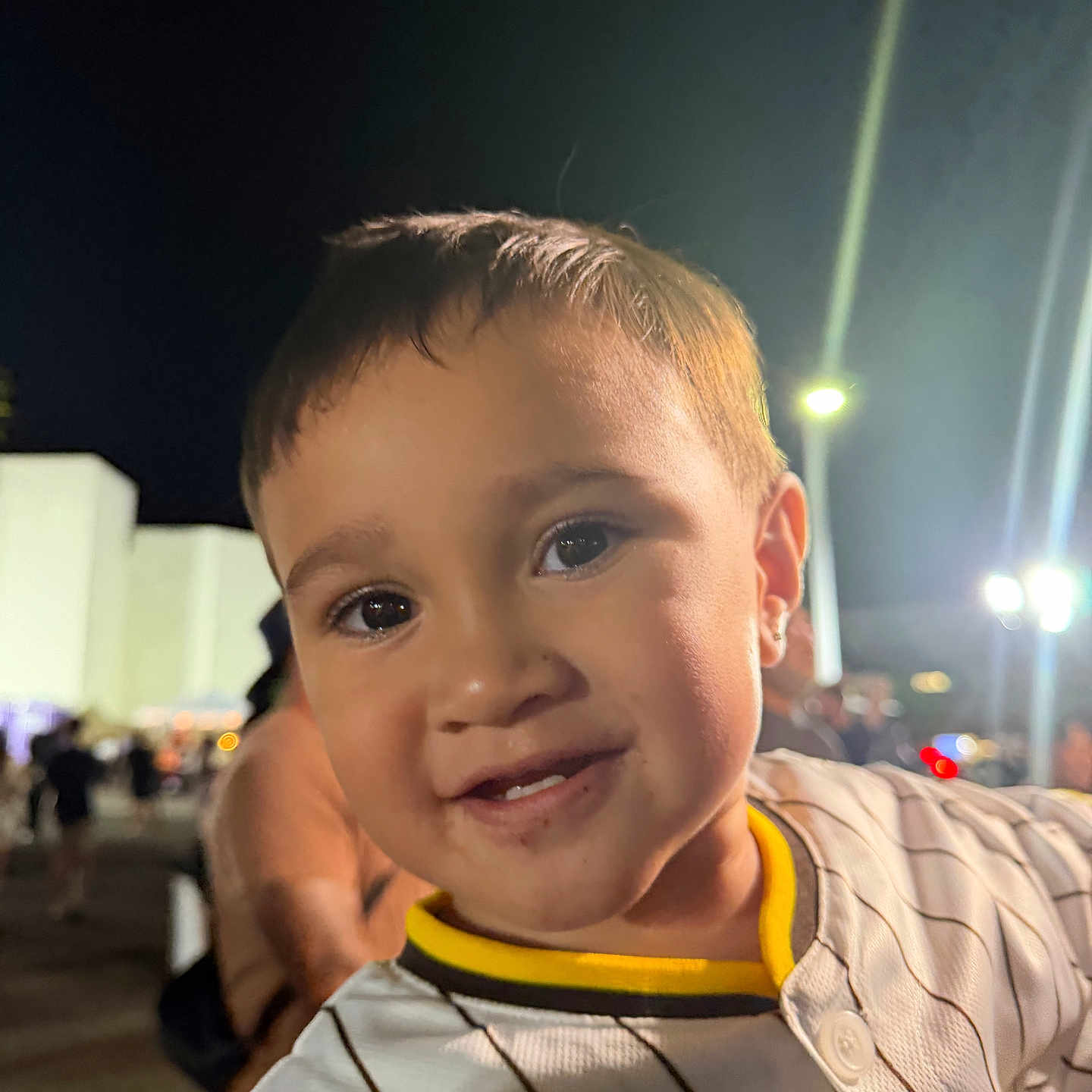 Zebediah is registered to the contest to win money with this photo: background, casual, child, closeup, clothing, crowd, cute, event, face, fun, happy, lights, night, outdoor, people, person, portrait, smiling, striped_shirt, young_child