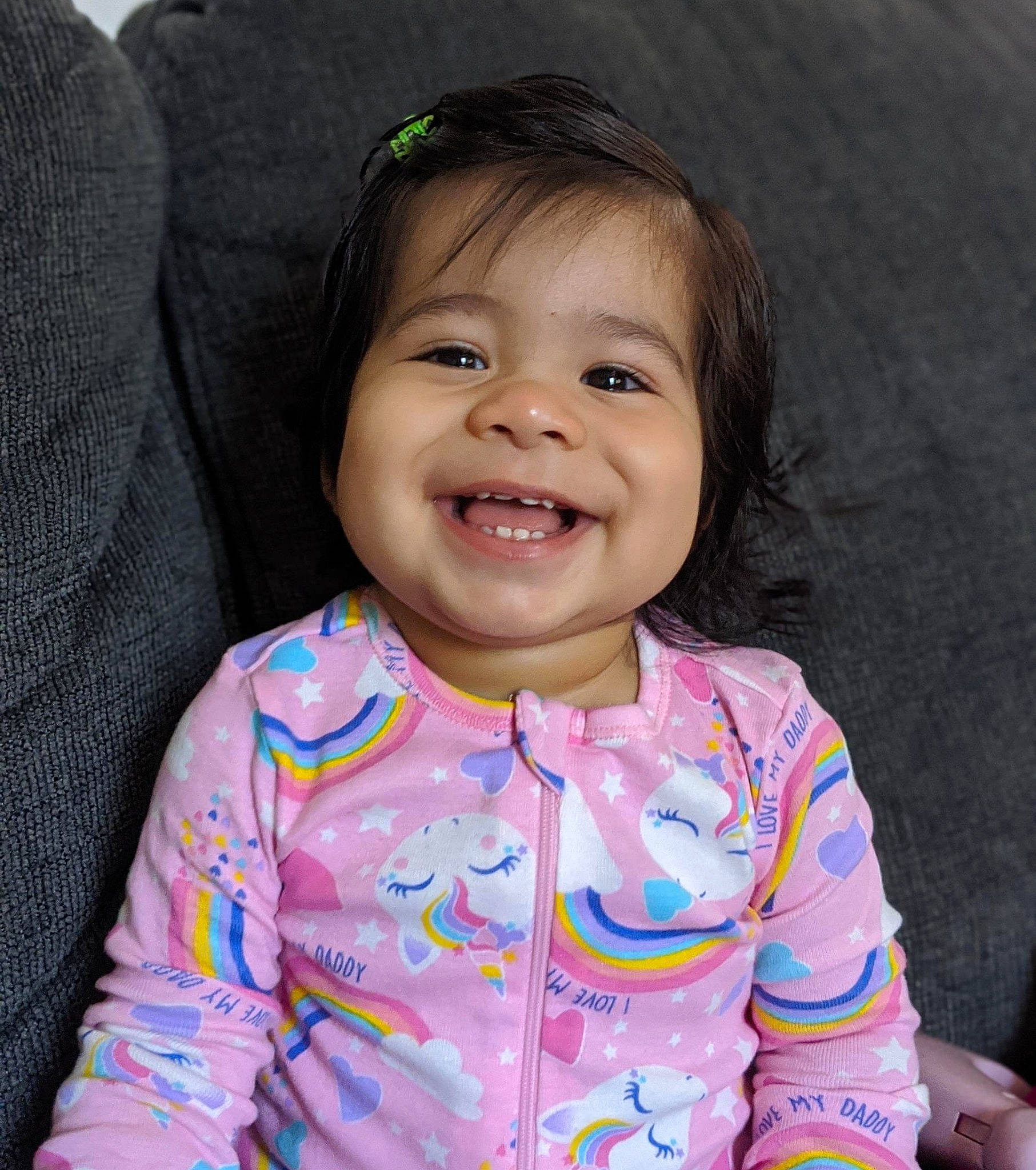 Aila is registered to the contest to win money with this photo: baby, beauty, cheek, child, chin, eye, face, facial_expression, fun, happy, head, iris, joy, laugh, lip, person, pink, sitting, skin, smile