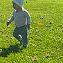 Arian is registered to the contest to win money with this photo: toddler, child, grass, outdoor, sunlight, hat, pants, shadow, field, greenery, playing, baby, walking, nature, daylight, person, young_child, exploring, casual_clothing, park