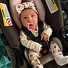 baby, infant, car_seat, pacifier, headband, pink, clothing, safety_harness, cute, child, indoors, portrait, person, seat, fabric, white_socks, patterned_pants, closeup, newborn, resting