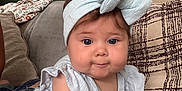 Madison is registered to the contest to win money with this photo: baby, child, headband, blue, couch, pillow, indoor, curious, face, person, clothing, infant, cute, home, soft, smiling, portrait, furniture, hand, sleeveless